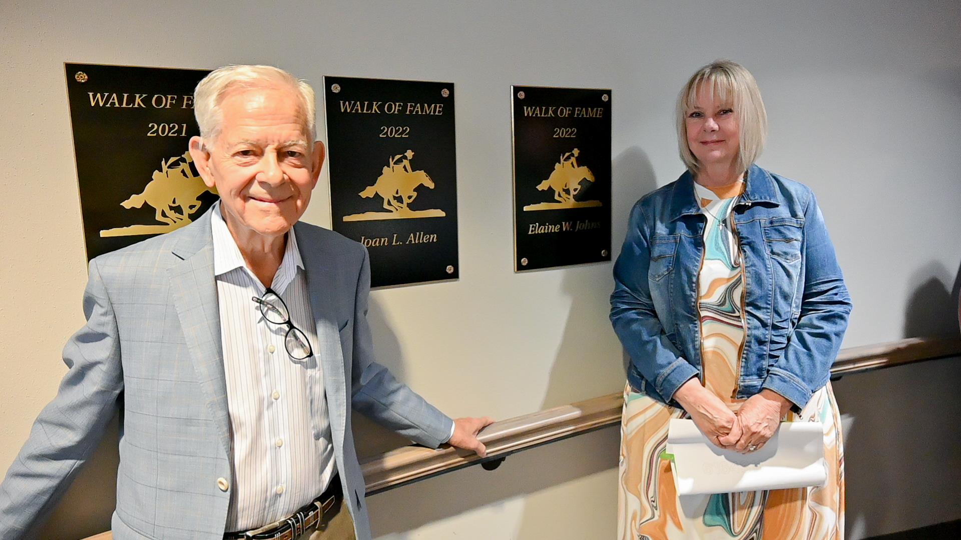 Elaine Johns standing next to Paul Allen in front of Walk of Honor Plaques